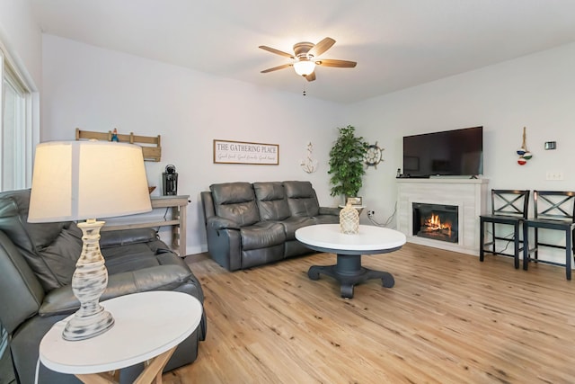 2394 Roberts Bend Rd, Burnside, KY 42519 - living area featuring a ceiling fan, light wood-style floors, and a glass covered fireplace