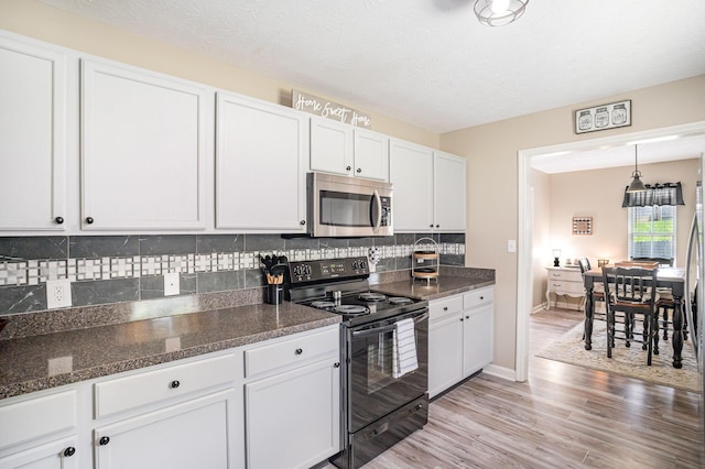 120 Eric Ct, Nicholasville, KY 40356 - kitchen featuring stainless steel microwave, electric range, white cabinets, and decorative backsplash