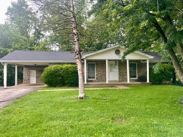 406 Forrest Dr, Lawrenceburg, KY 40342 - ranch-style house with driveway, a front yard, a porch, and an attached carport