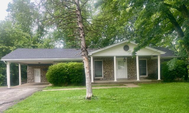 406 Forrest Dr, Lawrenceburg, KY 40342 - ranch-style home with asphalt driveway, a front lawn, a porch, stone siding, and a carport