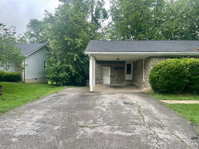 406 Forrest Dr, Lawrenceburg, KY 40342 - garage with asphalt driveway and an attached carport