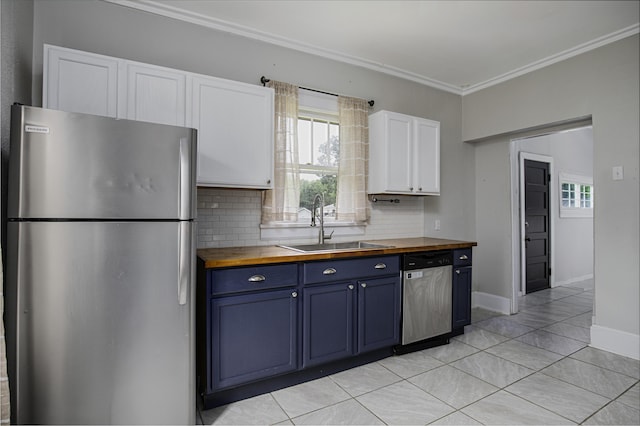 127 Locust Ave, Lexington, KY 40505 - kitchen with stainless steel appliances, butcher block countertops, blue cabinets, backsplash, and white cabinetry