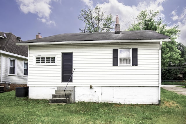 127 Locust Ave, Lexington, KY 40505 - rear view of house with a chimney, a yard, entry steps, and a shingled roof