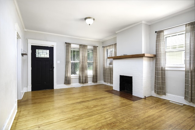127 Locust Ave, Lexington, KY 40505 - entryway with wood finished floors, a brick fireplace, plenty of natural light, and crown molding