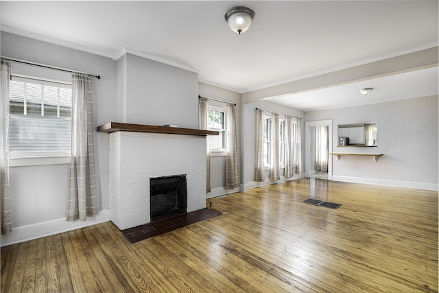 127 Locust Ave, Lexington, KY 40505 - unfurnished living room featuring a brick fireplace, hardwood / wood-style flooring, and crown molding