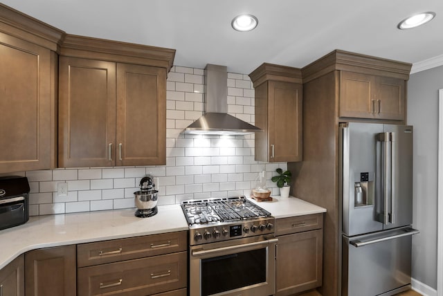 4109 Bridgemont Ln, Lexington, KY 40515 - kitchen featuring high end appliances, wall chimney exhaust hood, tasteful backsplash, light stone counters, and recessed lighting