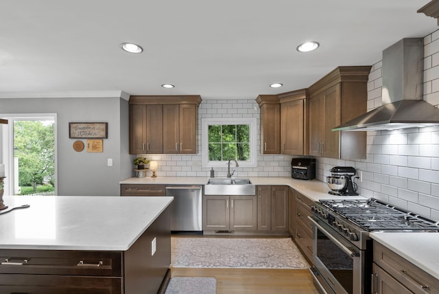 4109 Bridgemont Ln, Lexington, KY 40515 - kitchen with wall chimney range hood, appliances with stainless steel finishes, healthy amount of natural light, light wood-style floors, and recessed lighting