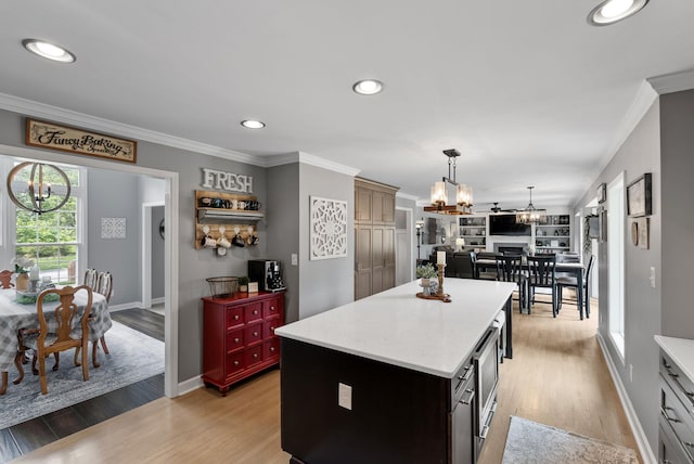 4109 Bridgemont Ln, Lexington, KY 40515 - kitchen with a chandelier, a kitchen island, crown molding, light wood-style flooring, and recessed lighting