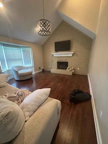 5 Abbey Ln, Middlesboro, KY 40965 - living area with wood finished floors, lofted ceiling, and a brick fireplace