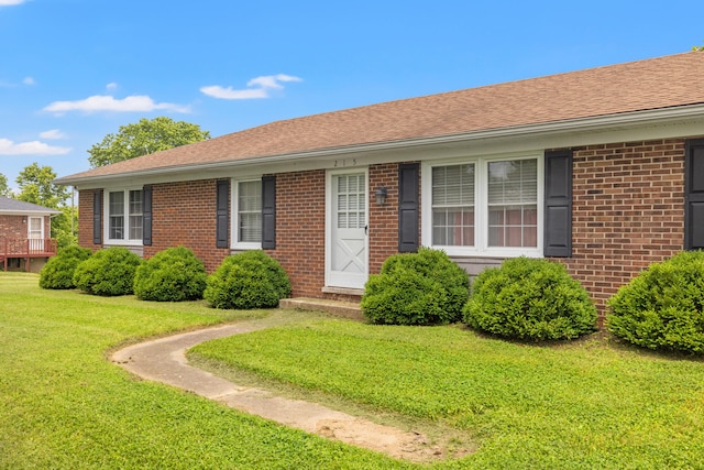 215 New Dixville Rd, Harrodsburg, KY 40330 - single story home featuring a front yard, brick siding, and a shingled roof