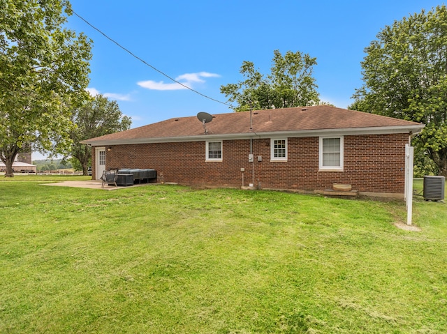 215 New Dixville Rd, Harrodsburg, KY 40330 - rear view of property featuring a patio area, a hot tub, a yard, and brick siding