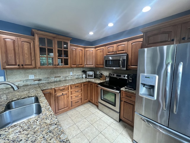 8585 Troy Pike, Versailles, KY 40383 - kitchen featuring stainless steel appliances, tasteful backsplash, glass insert cabinets, light stone counters, and recessed lighting
