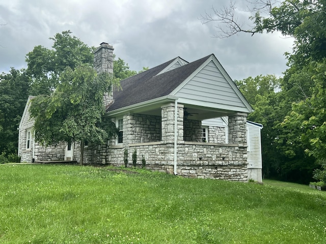 8585 Troy Pike, Versailles, KY 40383 - view of side of home with stone siding, a yard, a chimney, and ceiling fan