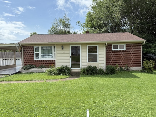 105 Kentucky Ave, Somerset, KY 42501 - view of front of house with a front lawn, brick siding, an attached carport, and roof with shingles