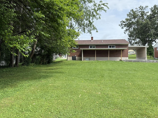 105 Kentucky Ave, Somerset, KY 42501 - rear view of house featuring a lawn, brick siding, and a chimney