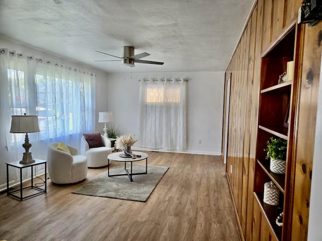 105 Kentucky Ave, Somerset, KY 42501 - living room featuring wood finished floors, a ceiling fan, a textured ceiling, and wood walls