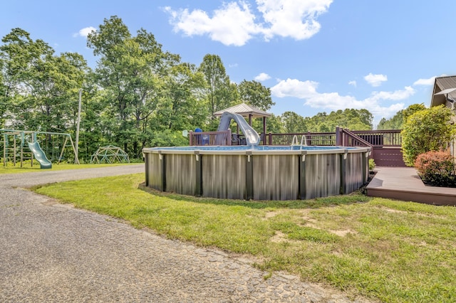 72 Blevins Ln, Vanceburg, KY 41179 - swimming pool featuring a deck, a lawn, a gazebo, a water slide, and a playground