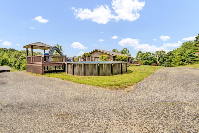 72 Blevins Ln, Vanceburg, KY 41179 - view of side of home featuring an outdoor pool, a yard, and a wooden deck