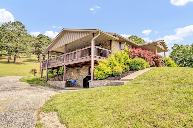 72 Blevins Ln, Vanceburg, KY 41179 - view of side of property with a yard, a wooden deck, and brick siding