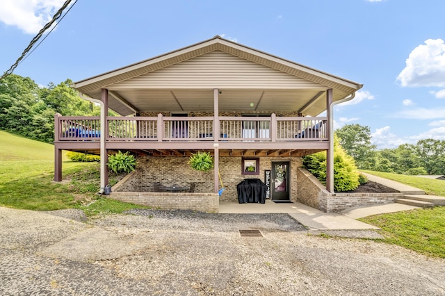 72 Blevins Ln, Vanceburg, KY 41179 - view of front of property featuring a deck, brick siding, and a front lawn