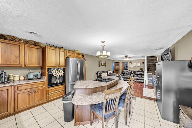 72 Blevins Ln, Vanceburg, KY 41179 - kitchen featuring black appliances, brown cabinets, a chandelier, open floor plan, and a textured ceiling