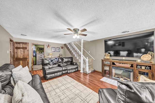 72 Blevins Ln, Vanceburg, KY 41179 - living room with stairs, ceiling fan, wood finished floors, and a textured ceiling