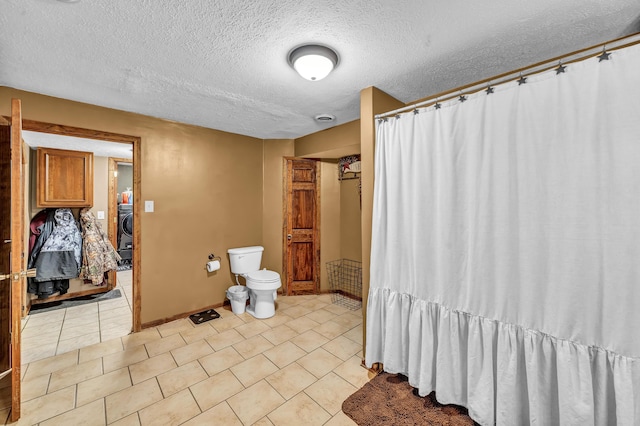 72 Blevins Ln, Vanceburg, KY 41179 - bathroom with a textured ceiling, tile patterned floors, curtained shower, and washer / dryer
