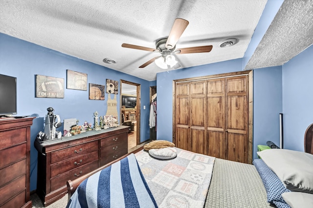 72 Blevins Ln, Vanceburg, KY 41179 - bedroom with a textured ceiling, a closet, and ceiling fan