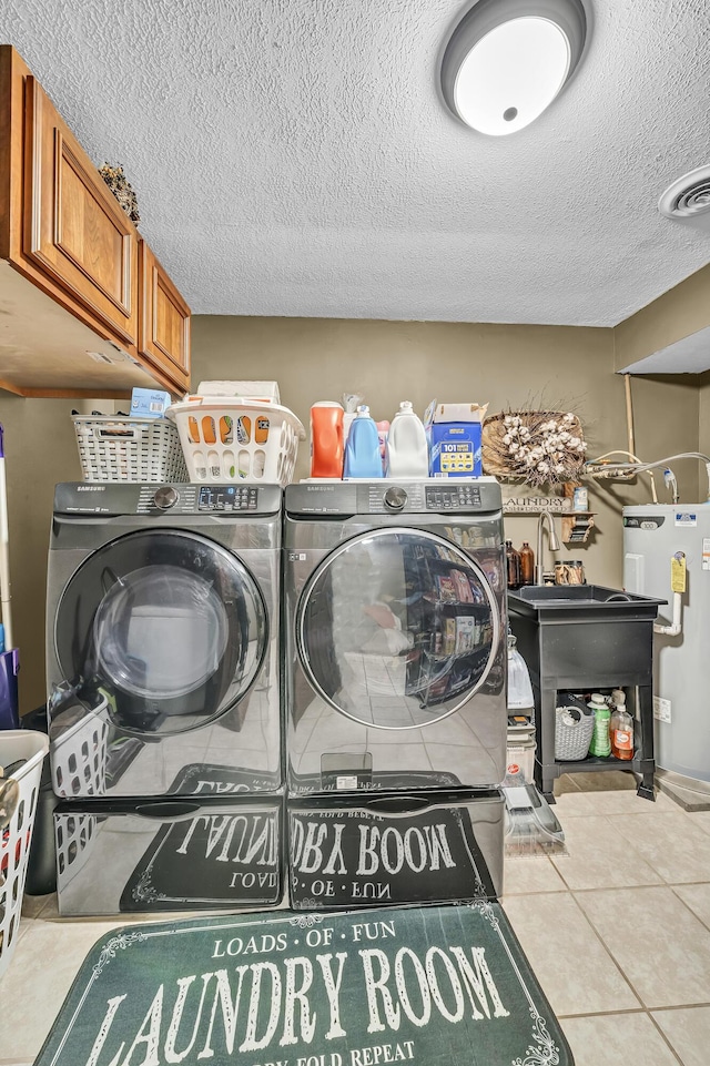 72 Blevins Ln, Vanceburg, KY 41179 - washroom featuring electric water heater, washing machine and dryer, a textured ceiling, tile patterned flooring, and cabinet space
