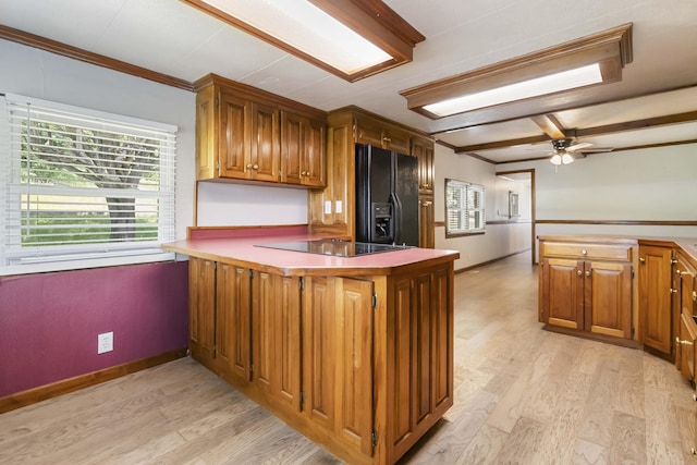 1751 Piney Grove Rd, Somerset, KY 42501 - kitchen with black appliances, a peninsula, crown molding, brown cabinets, and light wood finished floors