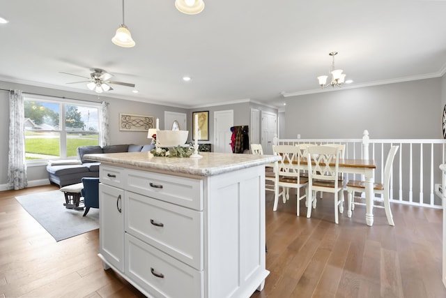 81 Grand Crossing Ct, Somerset, KY 42503 - kitchen with a ceiling fan, wood finished floors, a center island, white cabinetry, and crown molding