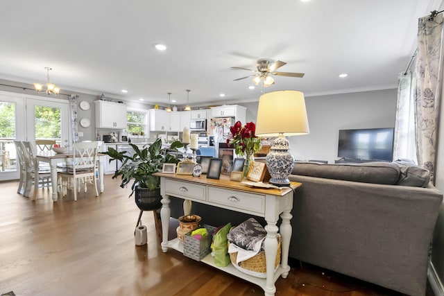 81 Grand Crossing Ct, Somerset, KY 42503 - living area featuring ornamental molding, a ceiling fan, wood finished floors, recessed lighting, and a chandelier