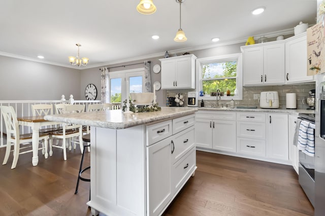 81 Grand Crossing Ct, Somerset, KY 42503 - kitchen featuring tasteful backsplash, crown molding, a kitchen breakfast bar, white cabinetry, and a chandelier