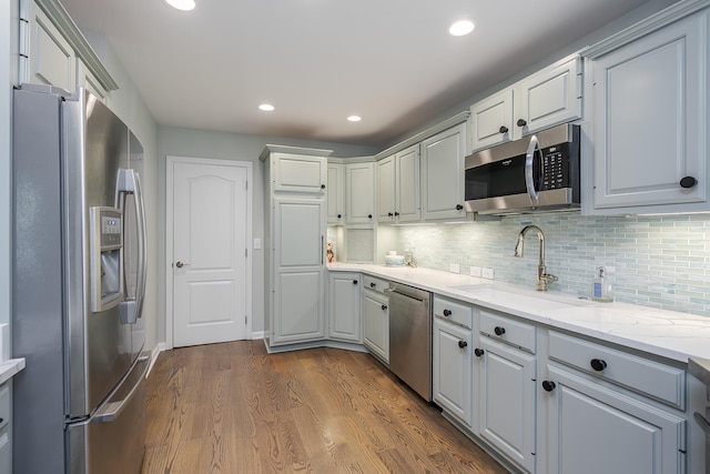 1107 Zoeller Ct, Lexington, KY 40511 - kitchen with appliances with stainless steel finishes, dark wood finished floors, backsplash, recessed lighting, and light stone counters