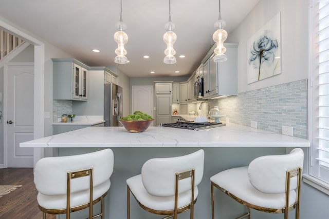 1107 Zoeller Ct, Lexington, KY 40511 - kitchen featuring stainless steel appliances, a peninsula, glass insert cabinets, light stone counters, and recessed lighting