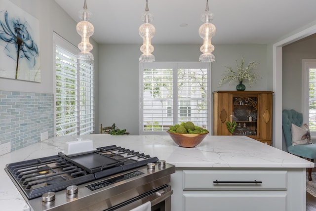 1107 Zoeller Ct, Lexington, KY 40511 - kitchen featuring stainless steel gas stove, white cabinetry, light stone counters, and decorative light fixtures