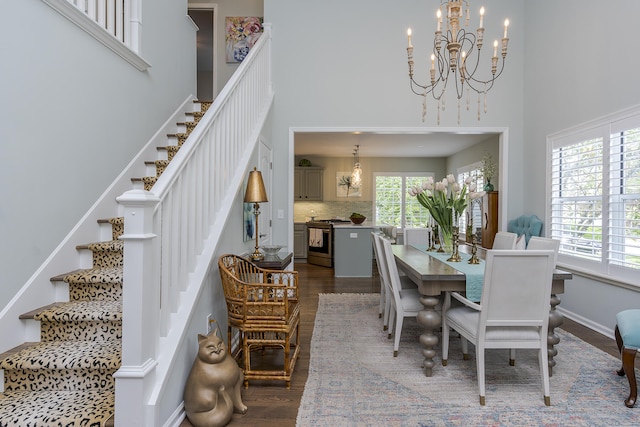 1107 Zoeller Ct, Lexington, KY 40511 - dining area featuring a chandelier, dark wood-type flooring, stairway, and a high ceiling