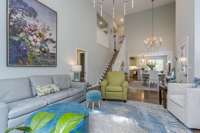 1107 Zoeller Ct, Lexington, KY 40511 - living room featuring stairway, a chandelier, a high ceiling, wood finished floors, and recessed lighting
