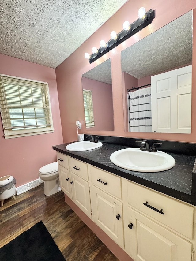 190 Keeneland Trl, Corbin, KY 40701 - full bath with a textured ceiling, double vanity, wood finished floors, and a shower with shower curtain