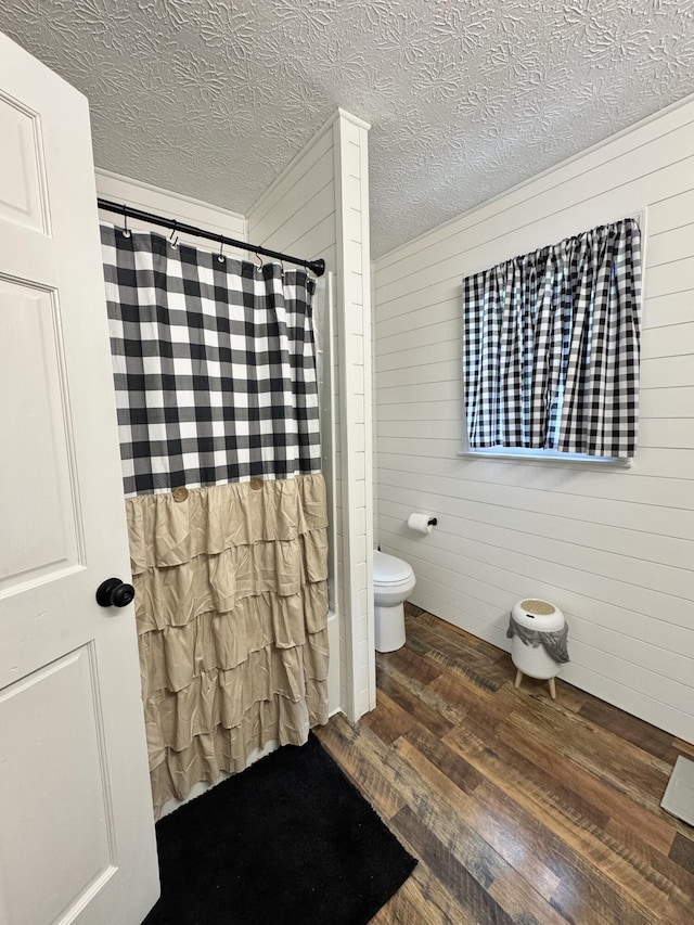190 Keeneland Trl, Corbin, KY 40701 - full bath featuring wood finished floors, wooden walls, a shower with shower curtain, and a textured ceiling