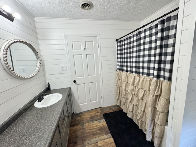 190 Keeneland Trl, Corbin, KY 40701 - bathroom with a textured ceiling, wood finished floors, wooden walls, and vanity