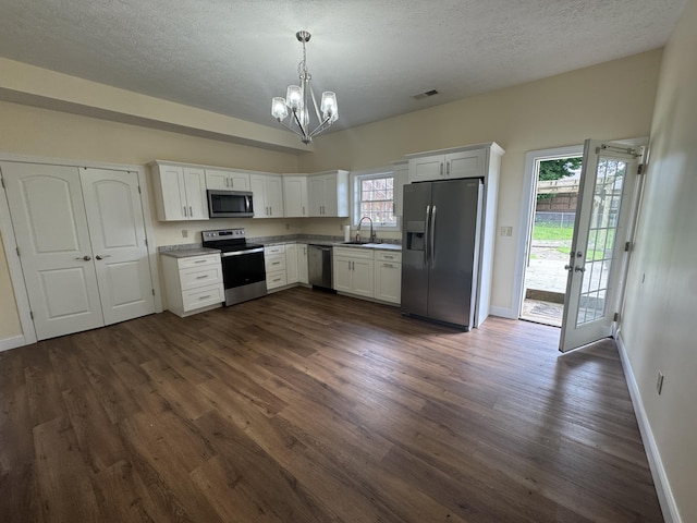 1459 Kit Cowan Rd, Somerset, KY 42501 - kitchen with appliances with stainless steel finishes, dark wood finished floors, a chandelier, white cabinetry, and a textured ceiling