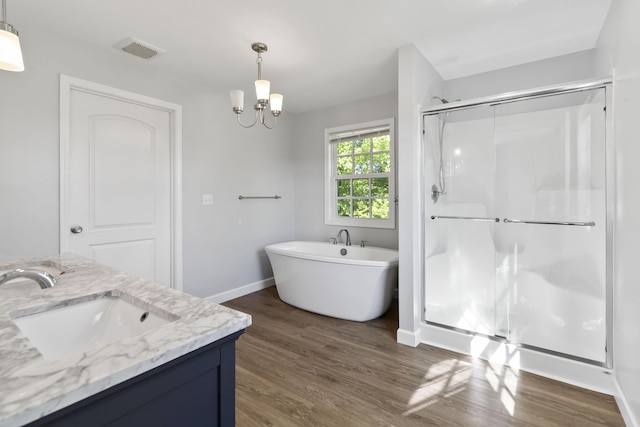 168 Kentucky Ln, Pine Knot, KY 42635 - bathroom featuring a stall shower, wood finished floors, vanity, a freestanding tub, and a chandelier