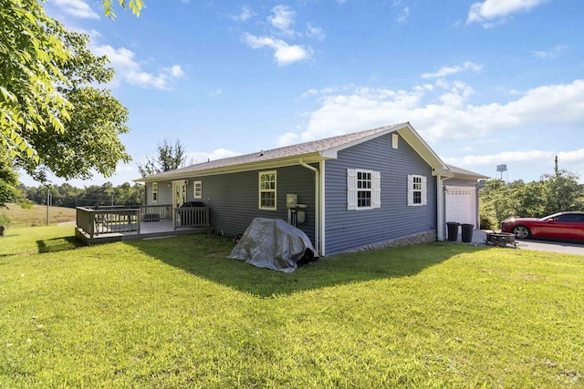 168 Kentucky Ln, Pine Knot, KY 42635 - rear view of property featuring a deck, a lawn, and a garage