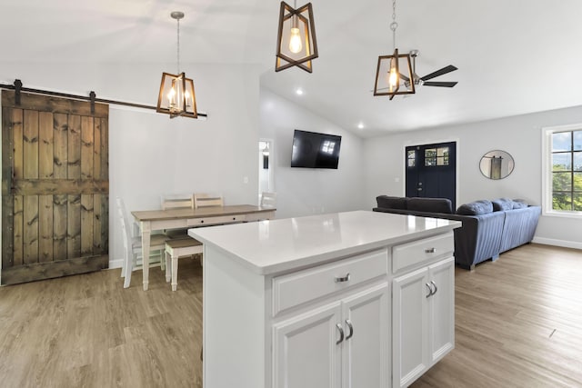 168 Kentucky Ln, Pine Knot, KY 42635 - kitchen with vaulted ceiling, open floor plan, light wood finished floors, hanging light fixtures, and a kitchen island