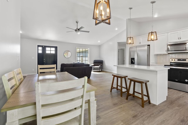 168 Kentucky Ln, Pine Knot, KY 42635 - dining room with lofted ceiling, a ceiling fan, light wood-type flooring, recessed lighting, and a chandelier