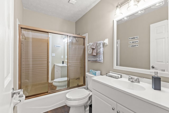 3848 Mcgarry Dr, Lexington, KY 40514 - full bathroom featuring vanity, combined bath / shower with glass door, and a textured ceiling