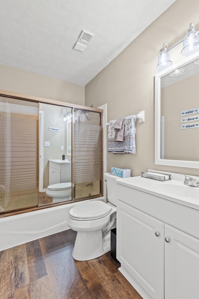 3848 Mcgarry Dr, Lexington, KY 40514 - full bath featuring vanity, wood finished floors, enclosed tub / shower combo, and a textured ceiling