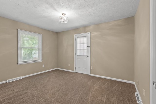 3848 Mcgarry Dr, Lexington, KY 40514 - empty room with carpet flooring, a textured ceiling, and a chandelier
