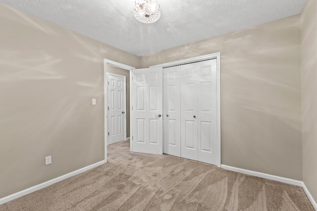 3848 Mcgarry Dr, Lexington, KY 40514 - unfurnished bedroom featuring carpet floors, a closet, and a textured ceiling